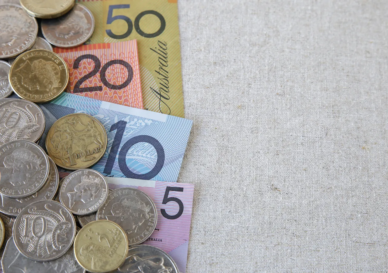 Australian banknotes and coins spread across a table.