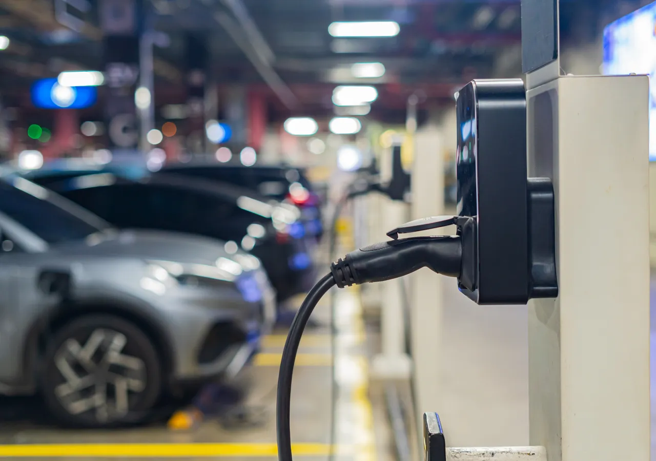 Public electric vehicle charging stations in an open-air car park.